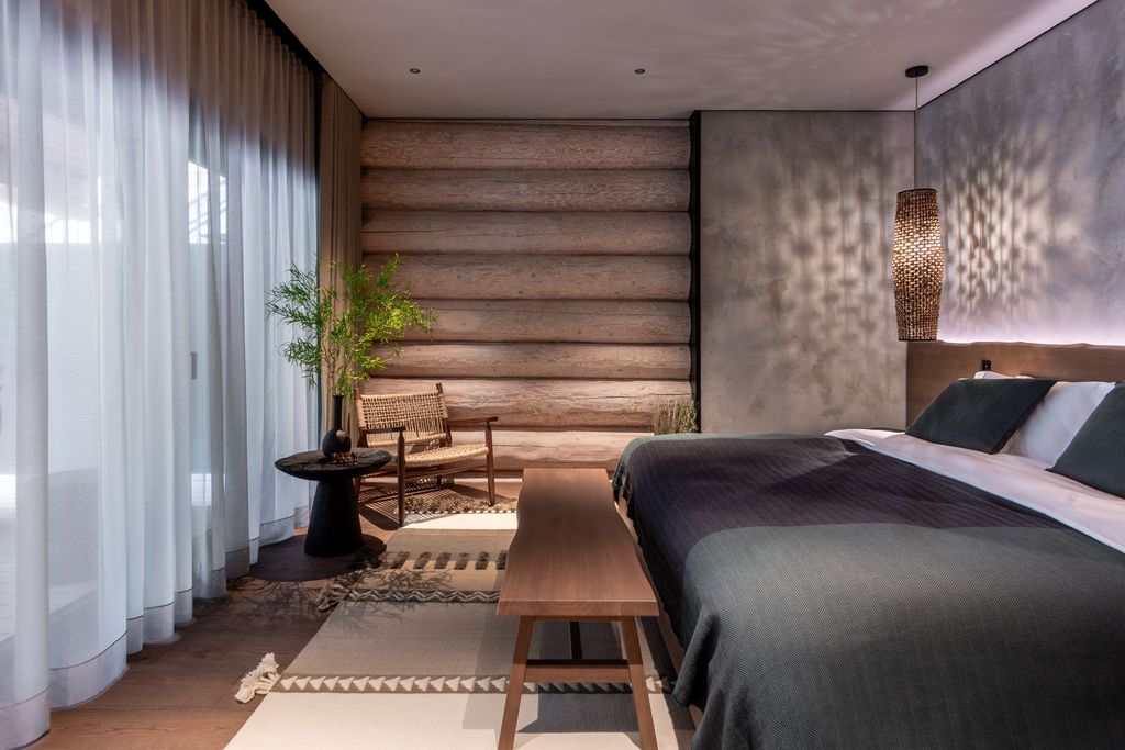 Forest suite interior with large windows, greenery outlook, and cozy ambience.