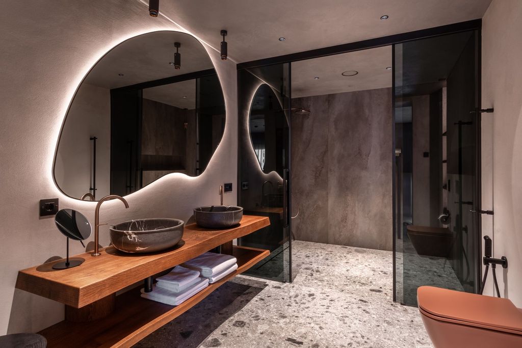 Elegant signature lakefront suite bathroom with refined wood accents and essential amenities.