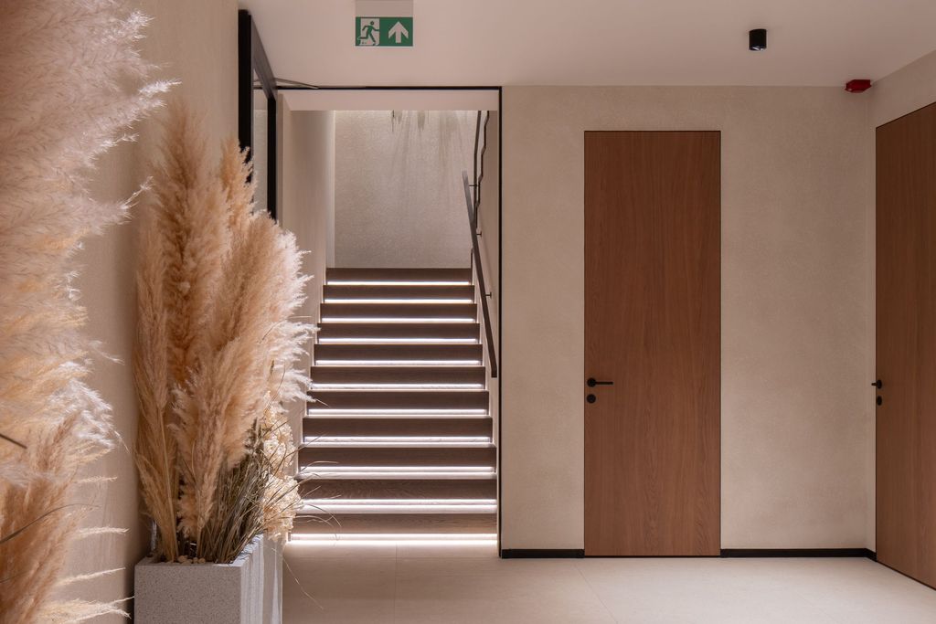 Elegant spa corridor with soft lighting and wood accents creating a peaceful path.