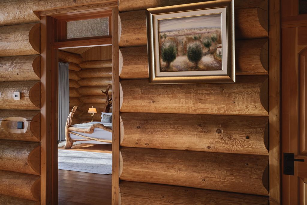 Lakefront private villa featuring modern interior with wooden wall decoration.