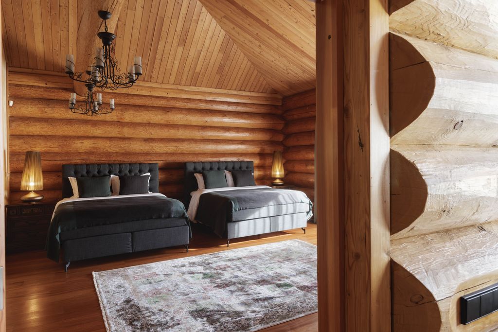 Large and elegant bedroom with two beds and calm tones for peaceful stays.