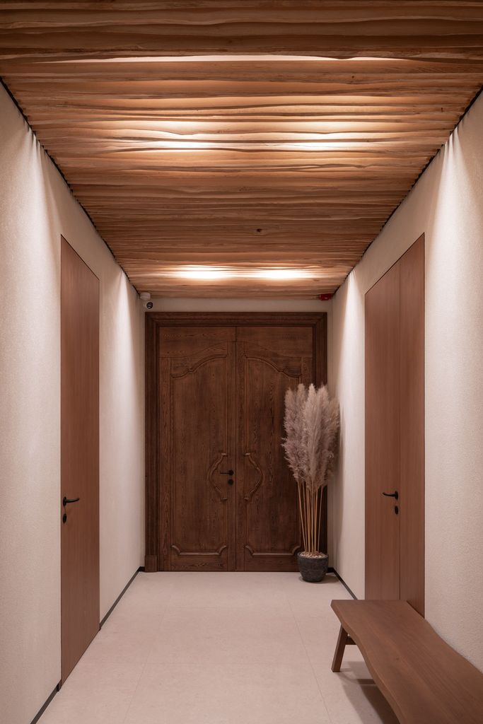 Calming spa hallway retreat with soft lighting and natural wood interior.