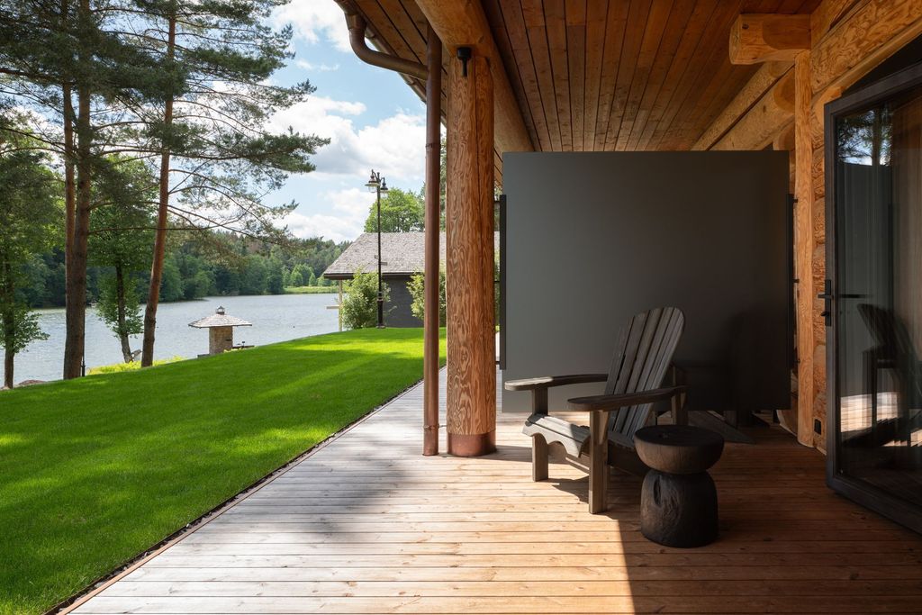 Sophisticated signature lakefront room at luxury resort with peaceful panoramic views.