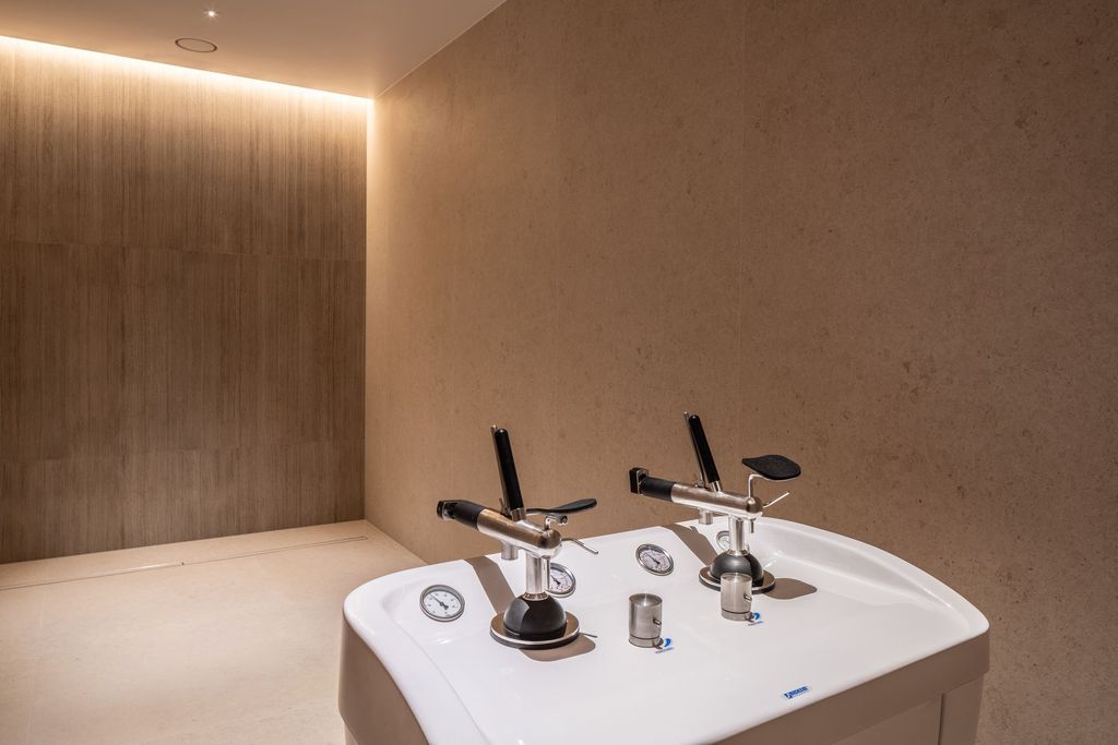 Calming treatment space with warm lighting and elegant design for wellness rituals.